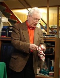 ...as Pat Page produces currency from an empty bag